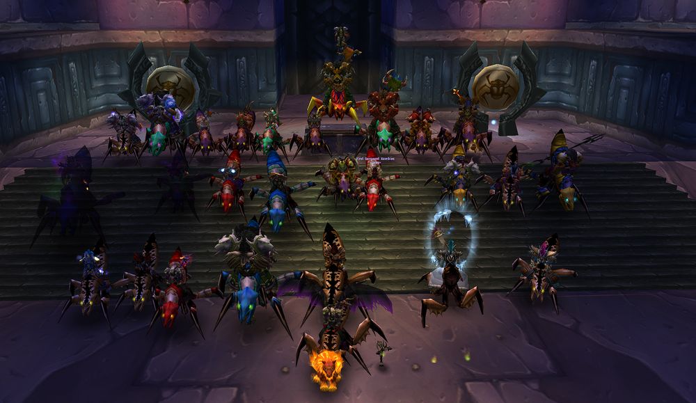 Forty Grim members mounted on purple Qiraji Battle Tanks, lined up in rows on the stone steps inside Ahn'Qiraj.