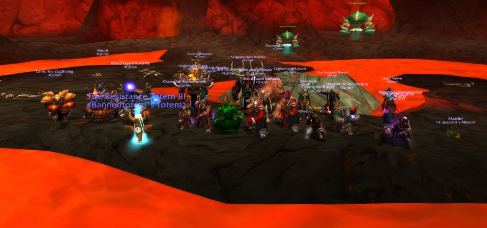 A Grim raid group on the black rock between lava flows in Molten Core, facing Duke Hydraxis, with a Fire Resistance Totem planted among them.